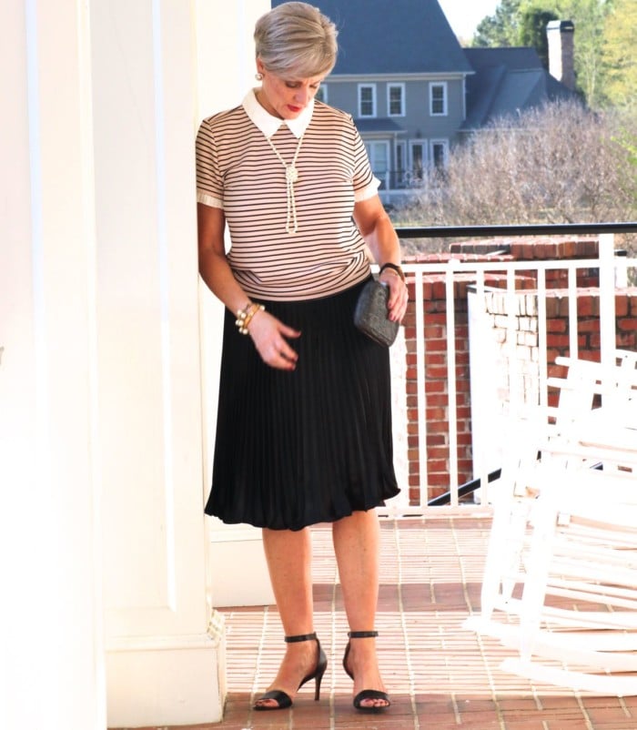 karl lagerfeld striped blouse black pleated skirt, black sandals, clutch