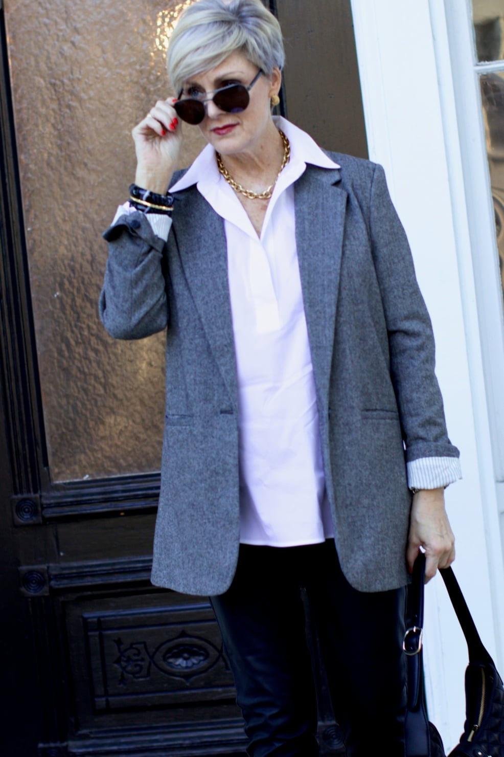 beth at Style at a Certain Age wears faux leather leggings, white shirt, boyfriend blazer, and black booties