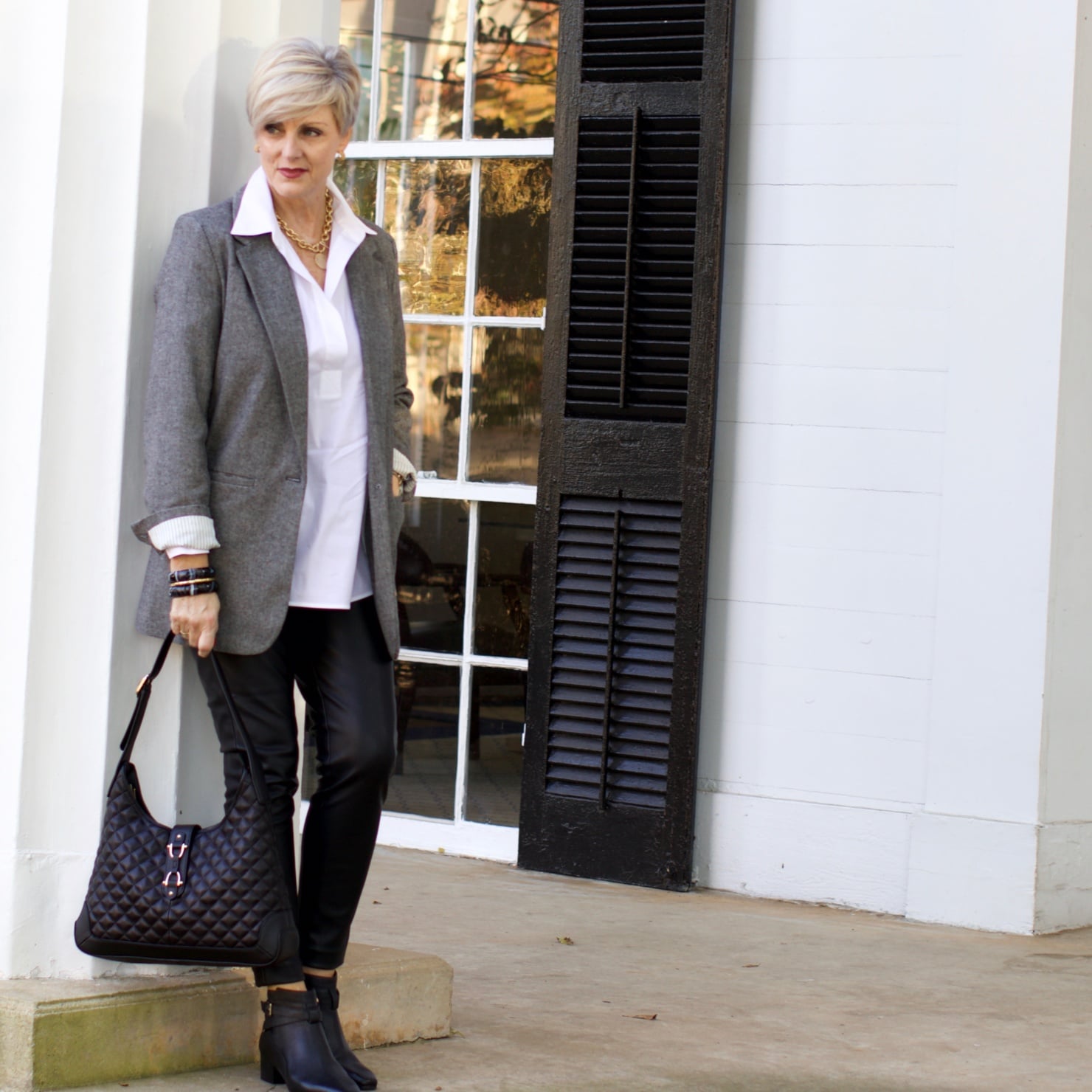 beth at Style at a Certain Age wears faux leather leggings, white shirt, boyfriend blazer, and black booties