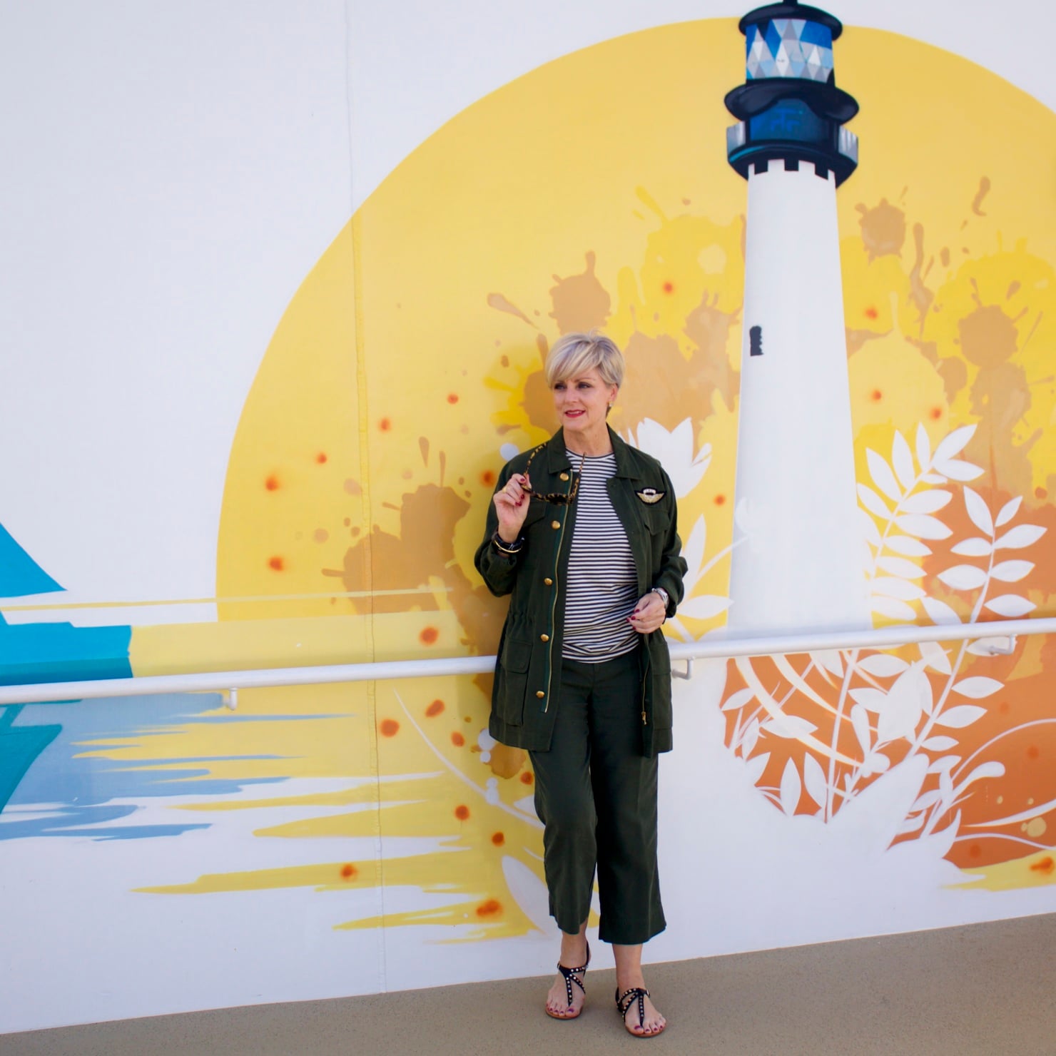 beth from Style at a Certain Age wears a Ralph Lauren military jacket, striped tee, and green cropped pants