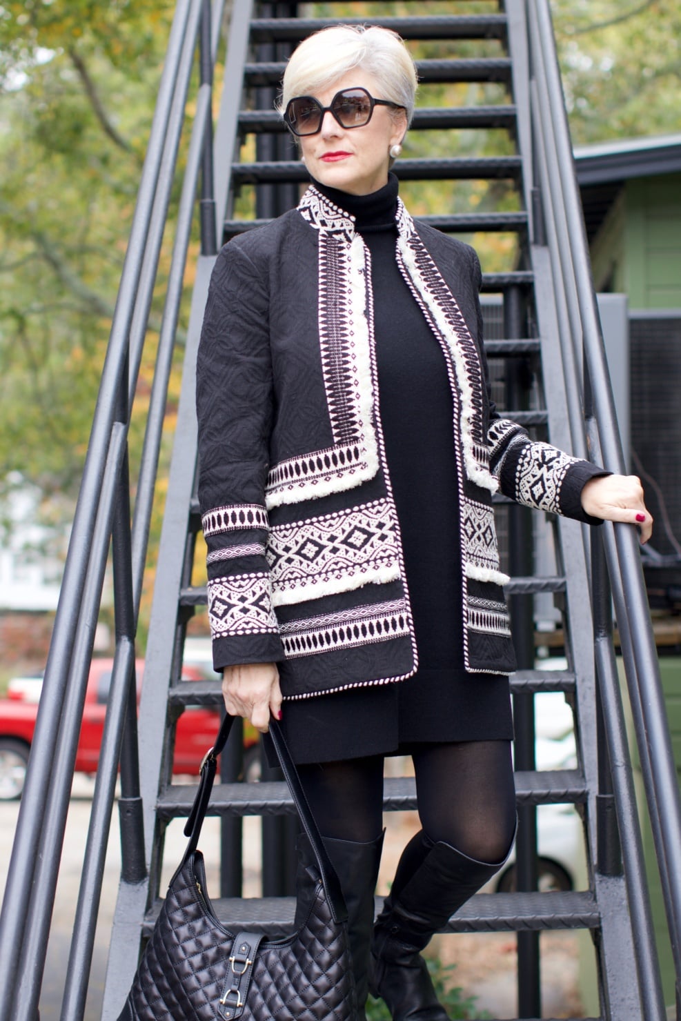 beth from style at a certain age wears a monochromatic outfit cashmere sweater dress from everlane, anthropologie embroidered jacket, black over the knee boots