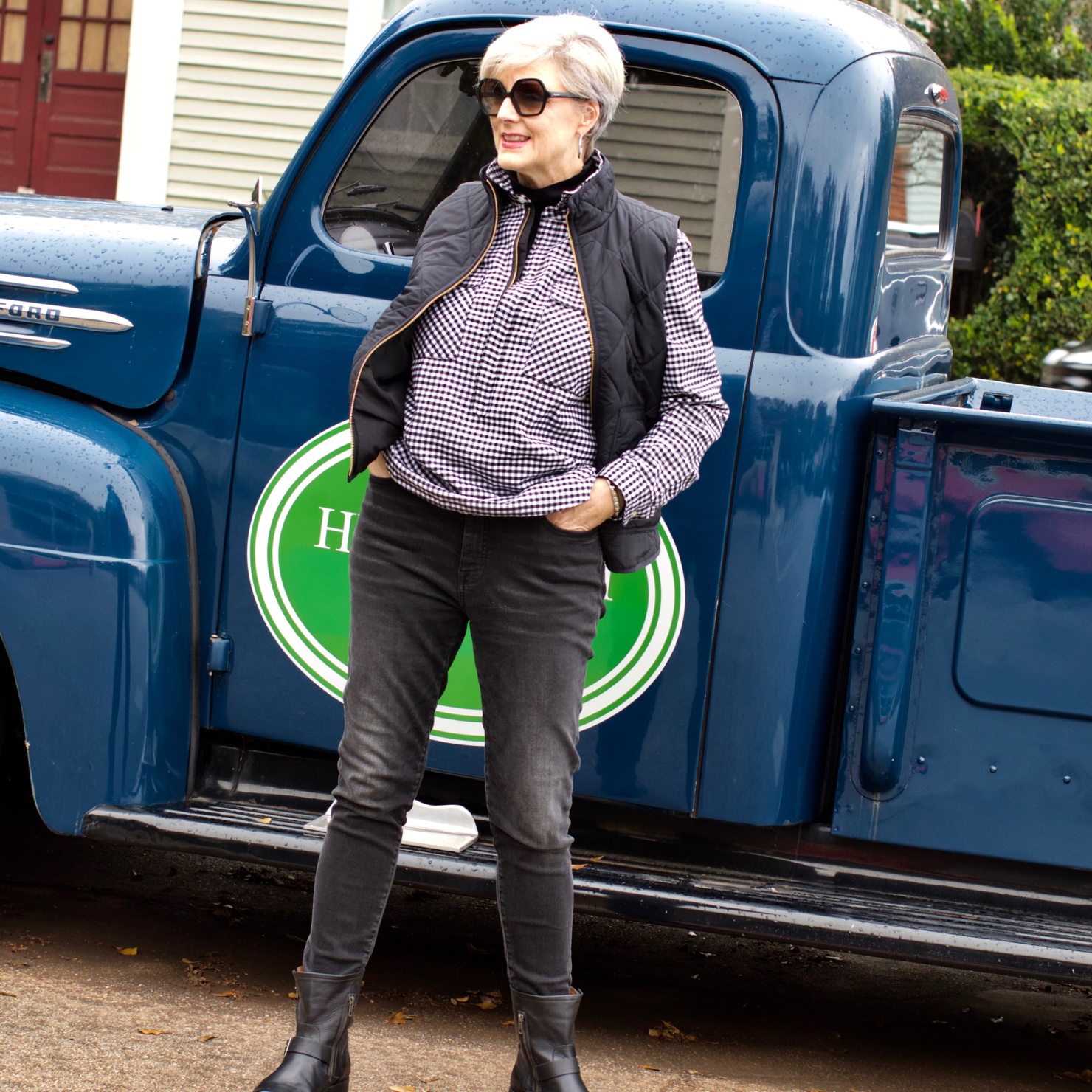 beth from style at a certain age wears high rise skinny jeans, tissue turtleneck, gingham shirt jacket, and puffer vest