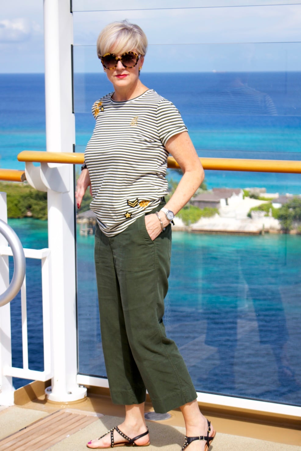 beth from Style at a Certain Age wears a Ralph Lauren military jacket, striped tee, and green cropped pants