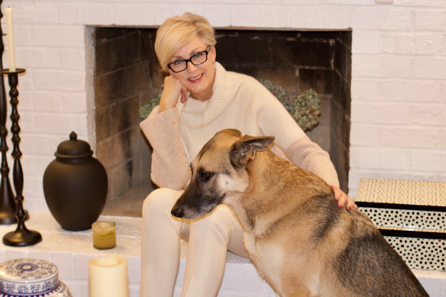 beth from Style at a Certain Age wears a cashmere color block sweater, slim leg ivory pants, cap toe ballet flats