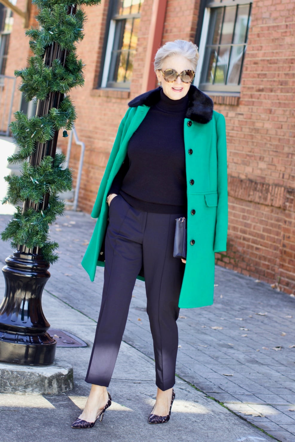 beth from Style at a Certain Age wears an Everlane cashmere turtleneck, Italian weave ankle pants, leopard pumps, and Talbots green overcoat