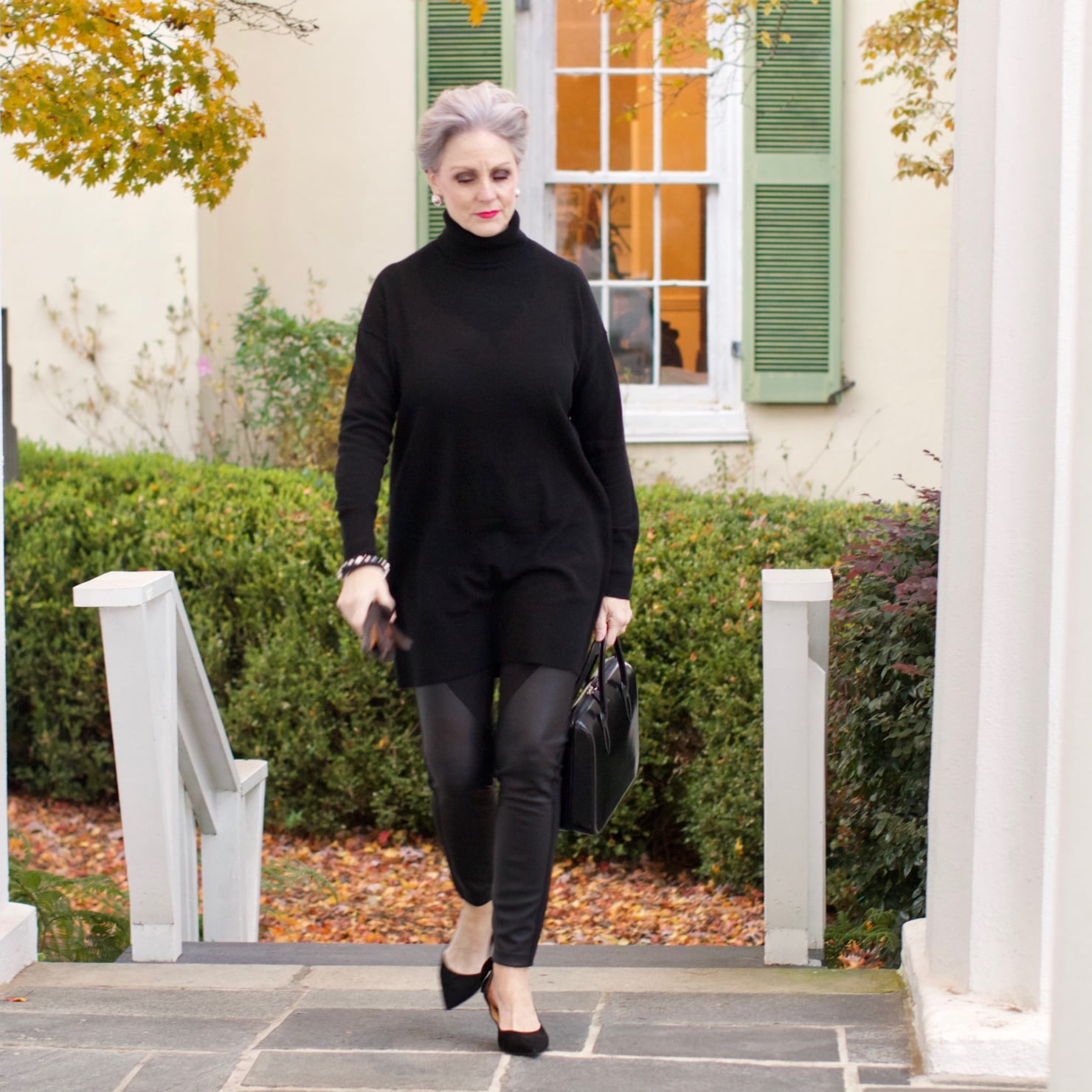 beth from Style at a Certain Age wears a black cashmere Turtleneck dress, faux leather leggings and suede pumps.