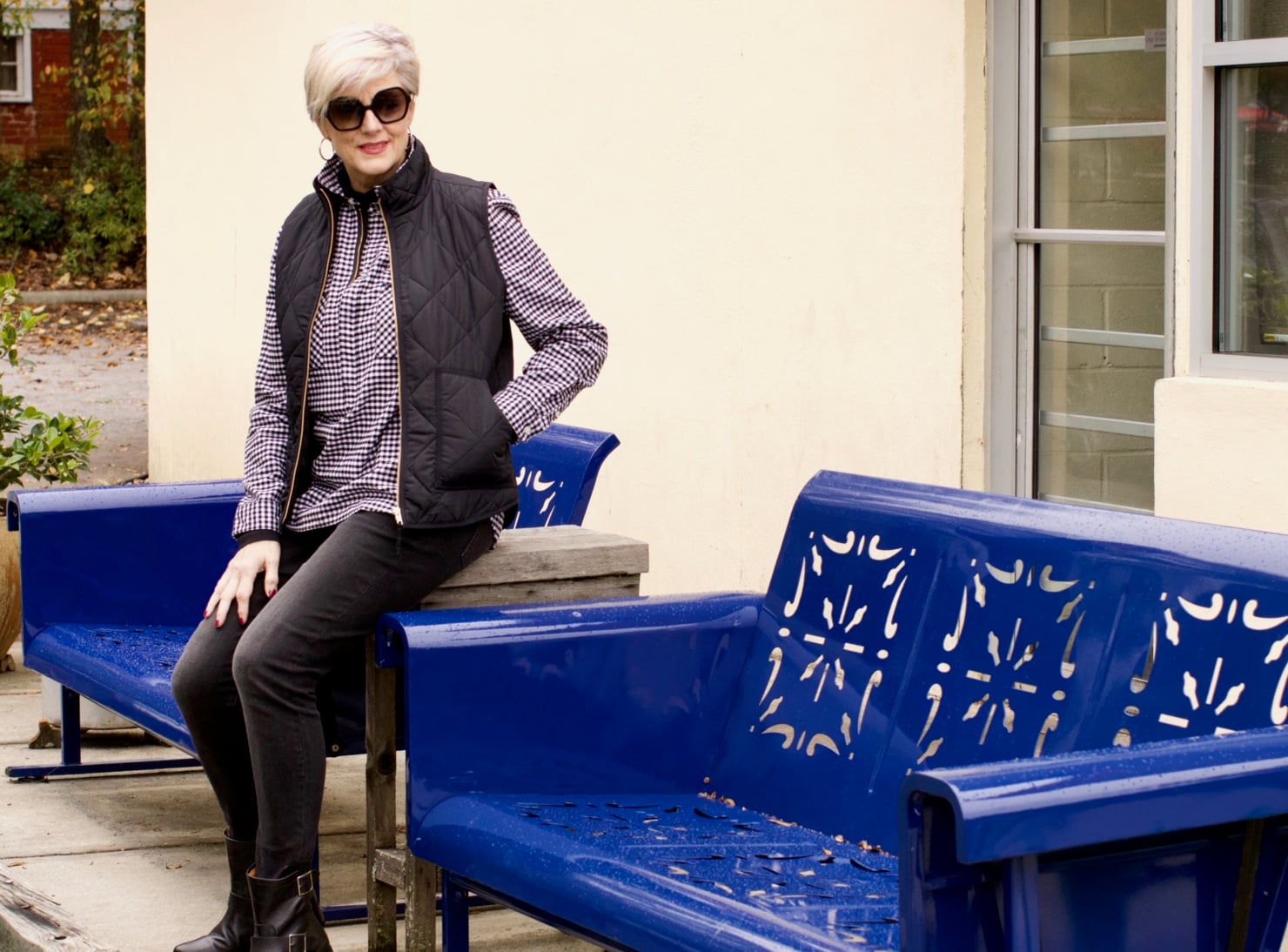 beth from style at a certain age wears high rise skinny jeans, tissue turtleneck, gingham shirt jacket, and puffer vest
