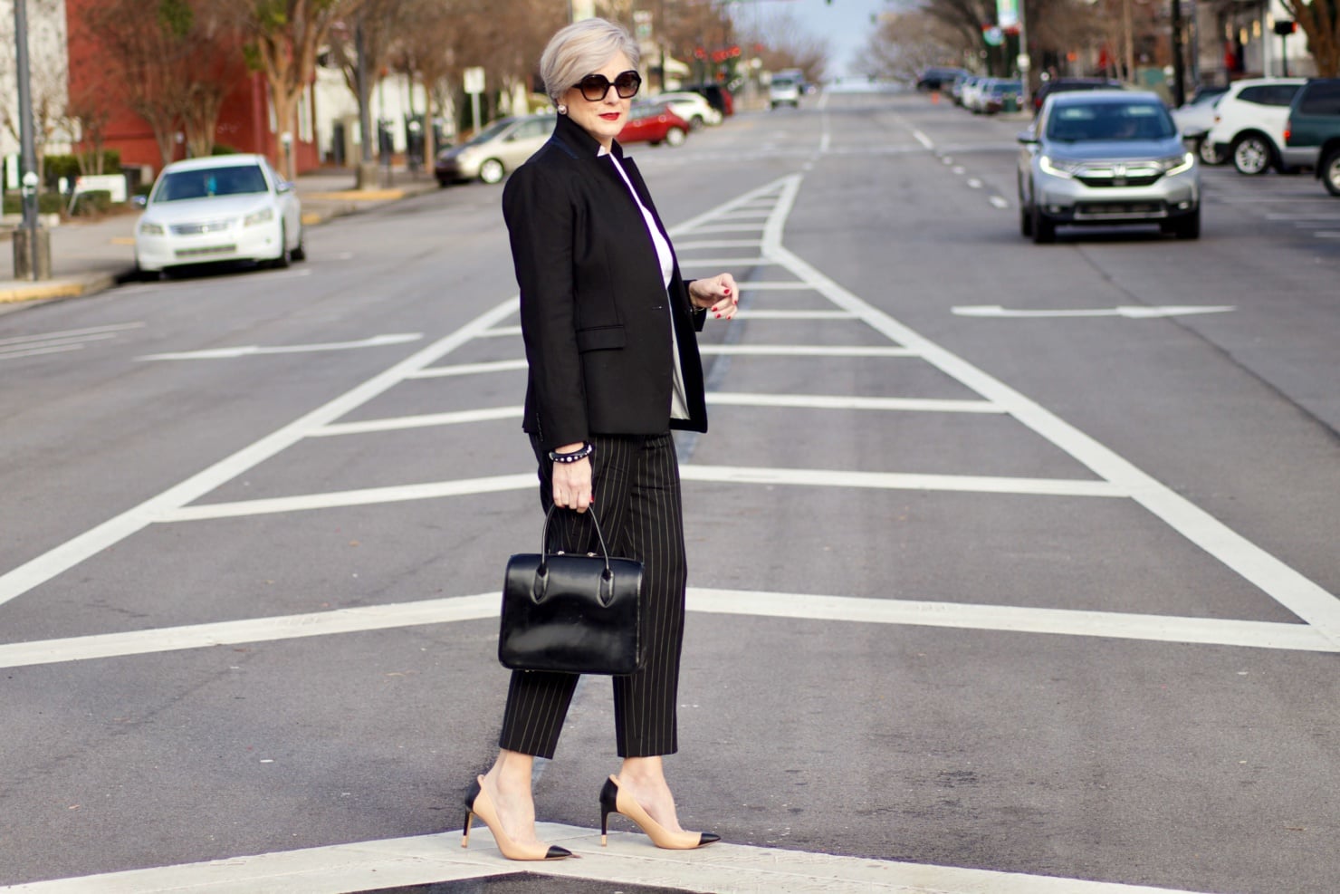 beth from Style at a Certain Age wears Ralph Lauren pinstripe pants, Misook white blouse, J.Crew black blazer, cap toe pumps and black handbag
