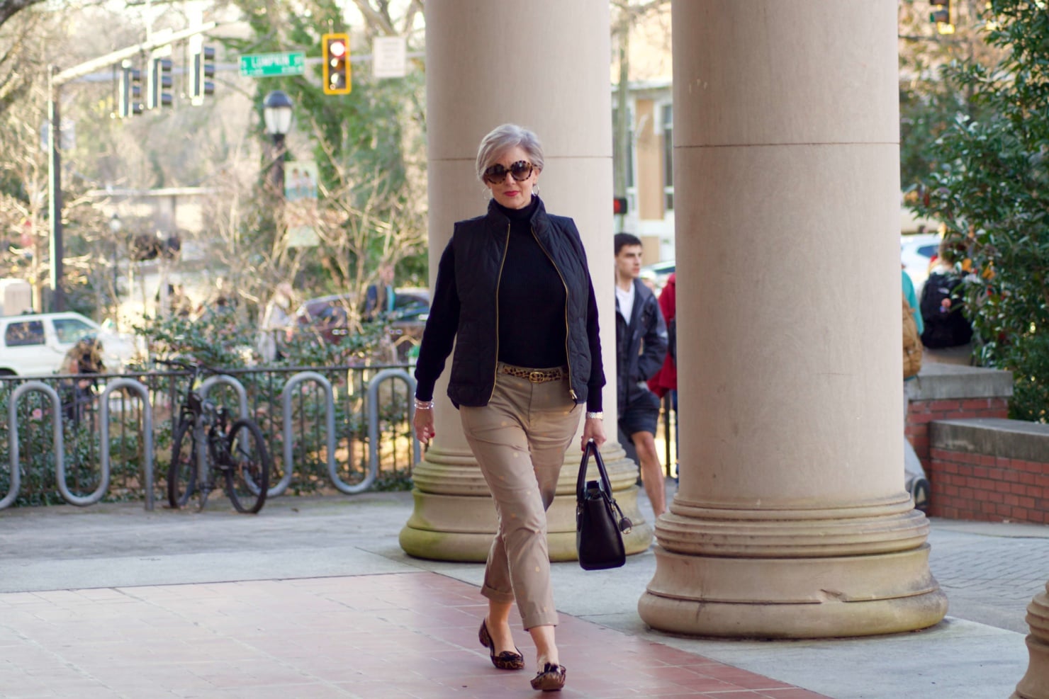 beth from Style at a Certain Age wears J.Crew polka dot chinos, Everlane cashmere waffle turtleneck, J.Crew Factory puffer vest, and Ann Taylor leopard flats
