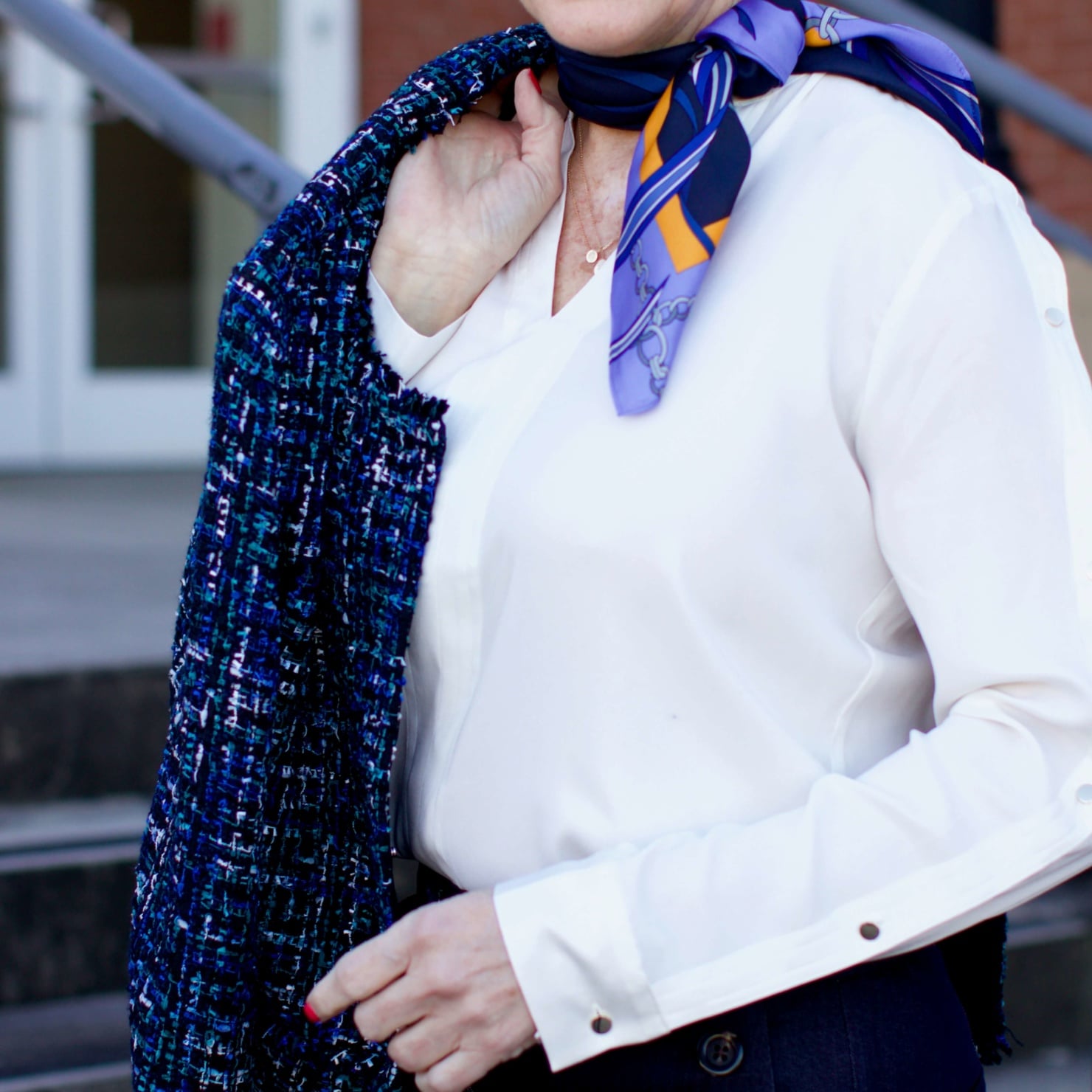 beth from Style at a Certain Age wears an Ann Taylor blue tweed jacket, faux denim sailor pants, v neck button sleeve blouse, silk ribbon chain scarf, and pointy toe booties
