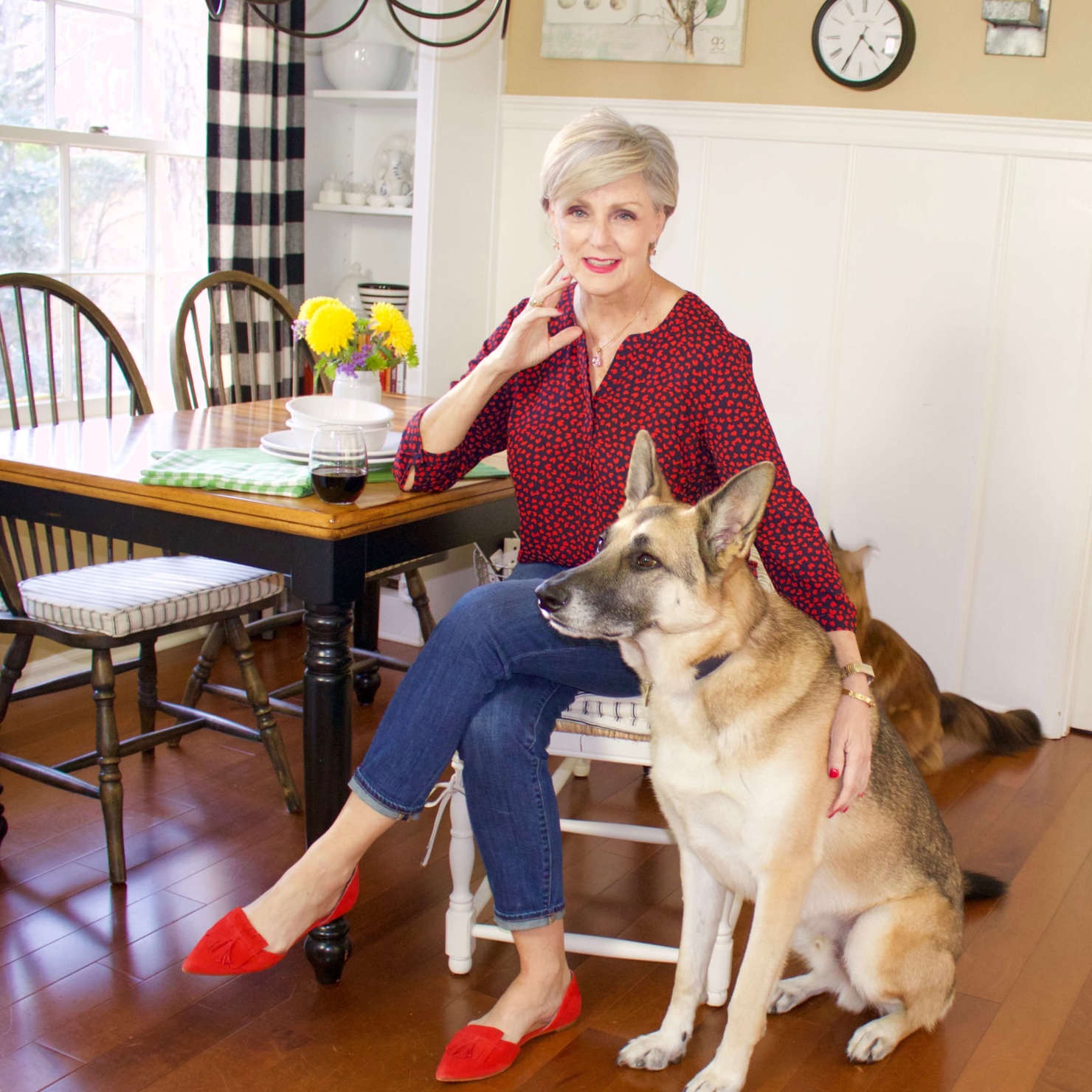beth from Style at a Certain Age wears a Talbots red heart blouse, girlfriend jeans, and red shoes