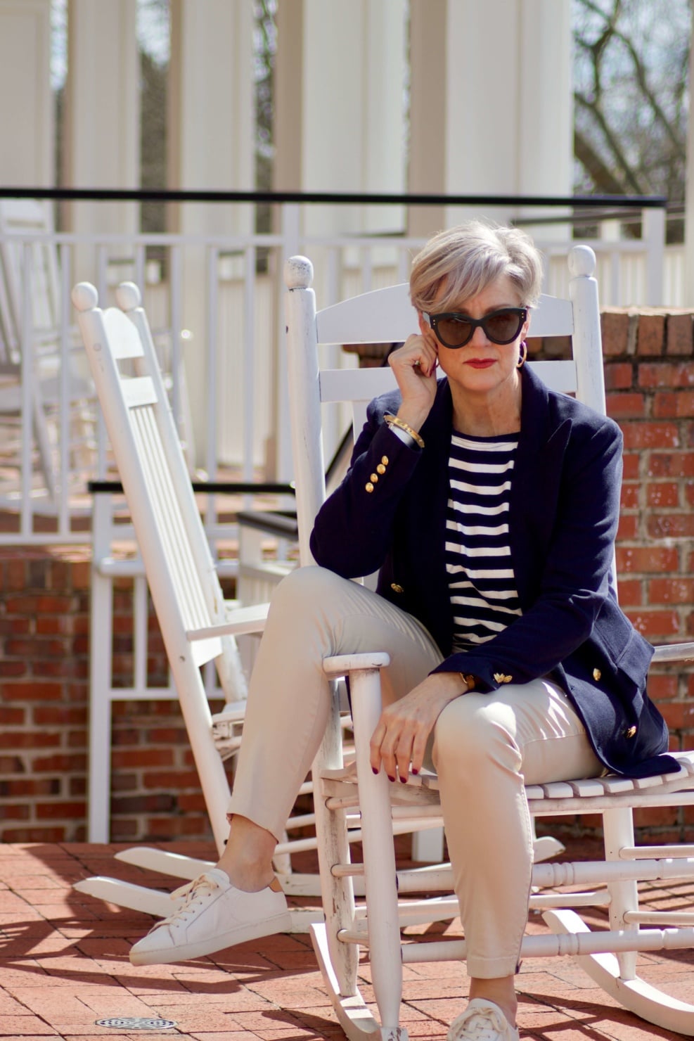 beth from Style at a Certain Age wears J.Crew striped tee, chinos, Ralph Lauren navy blue knit blazer, and white sneakers