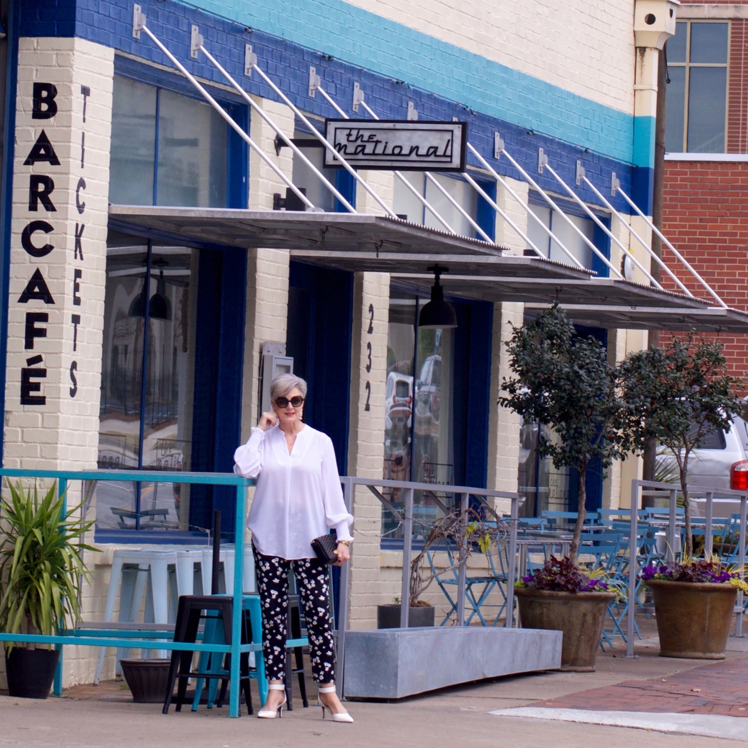 beth from Style at a Certain Age wears an outfit from Lord & Taylor, black pattern pants, white tunic blouse, Sam Edelman shoes