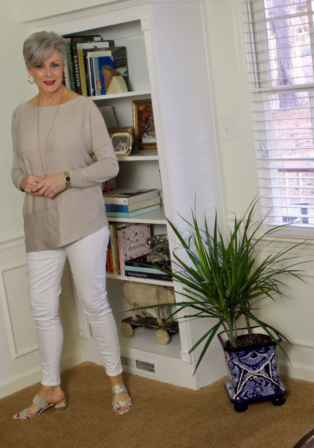 beth from Style at a Certain Age wears spring neutrals, white denim, asymmetrical tunic, snakeskin sandals