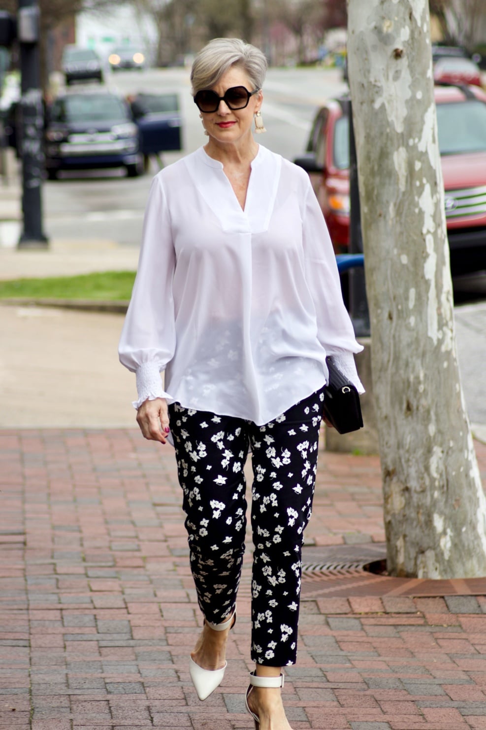 beth from Style at a Certain Age wears an outfit from Lord & Taylor, black pattern pants, white tunic blouse, Sam Edelman shoes