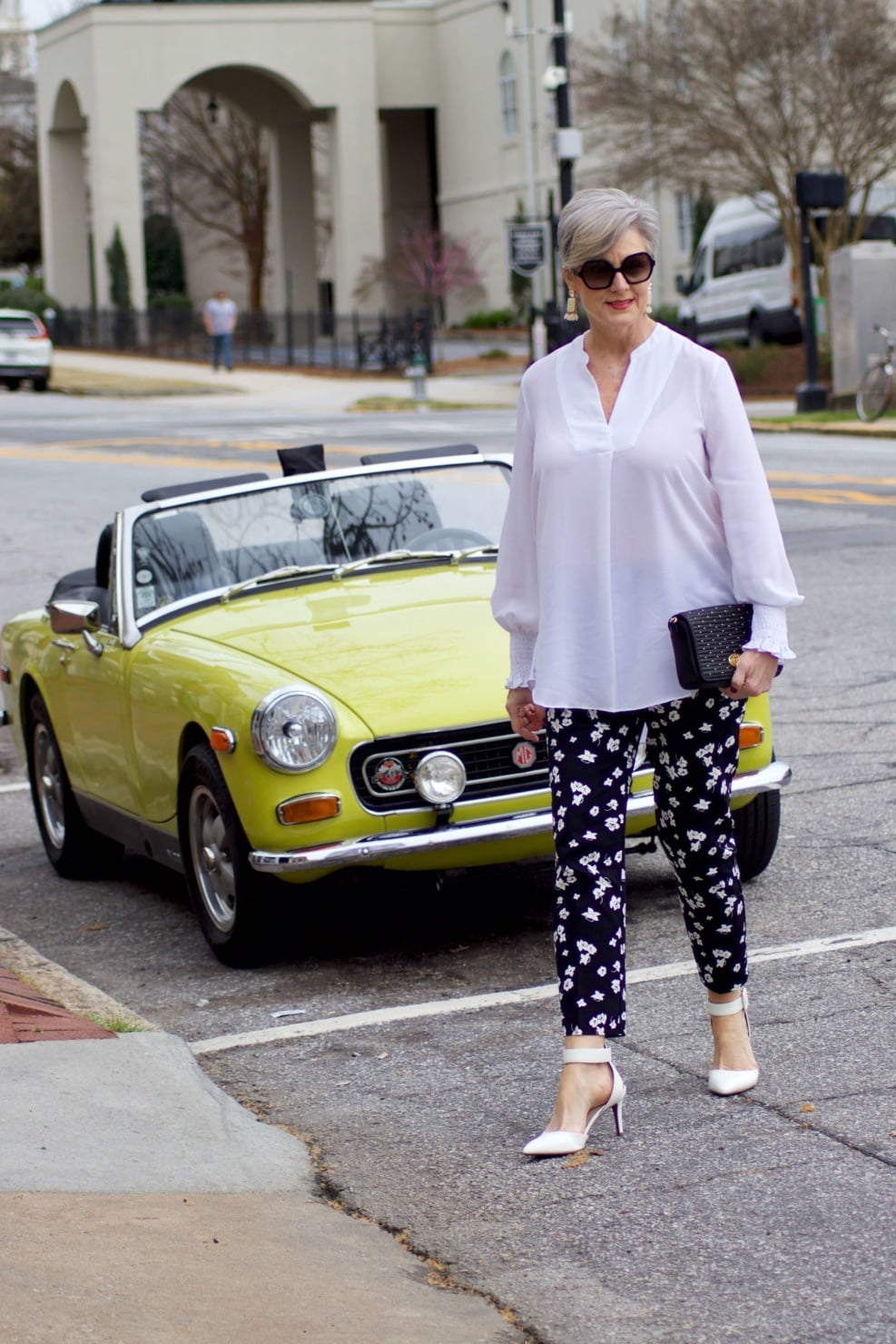beth from Style at a Certain Age wears an outfit from Lord & Taylor, black pattern pants, white tunic blouse, Sam Edelman shoes