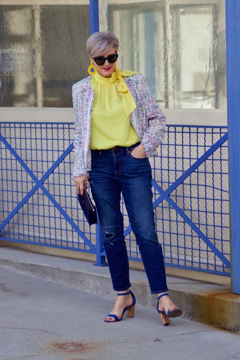 beth from Style at a Certain Age wears a tweed jacket from JC Penney, yellow tie blouse, distressed denim and sandals