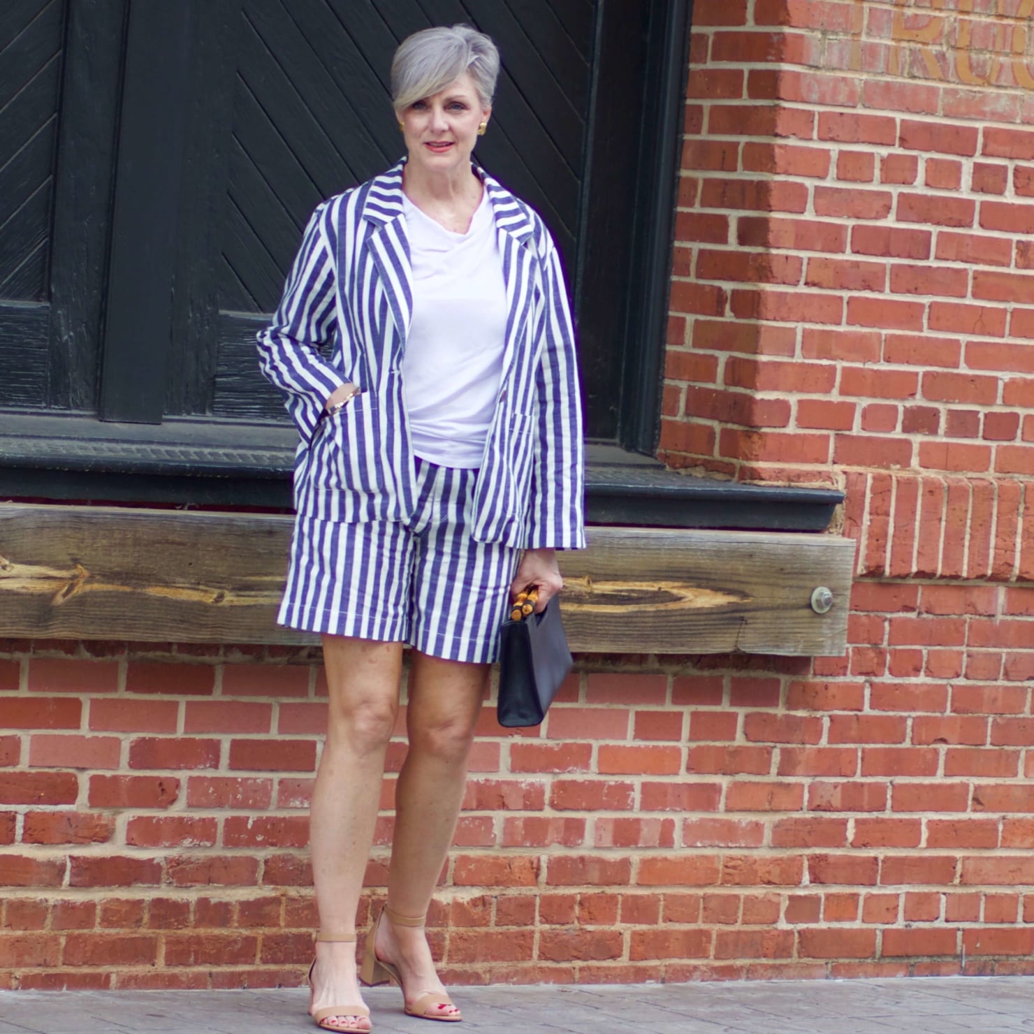 beth from Style at a Certain Age wears striped shorts, striped blazer, white tee, nude block heels