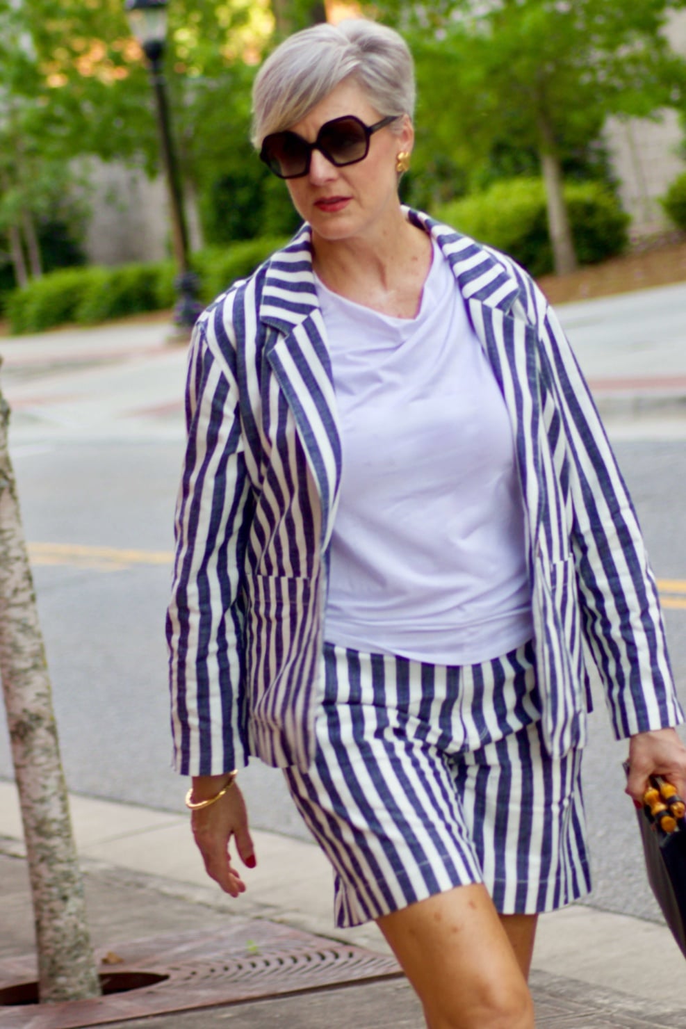 beth from Style at a Certain Age wears striped shorts, striped blazer, white tee, nude block heels