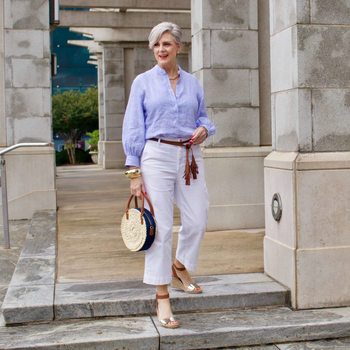 cropped white denim, striped linen shirt, cornhusk handbag, and wedge sandals