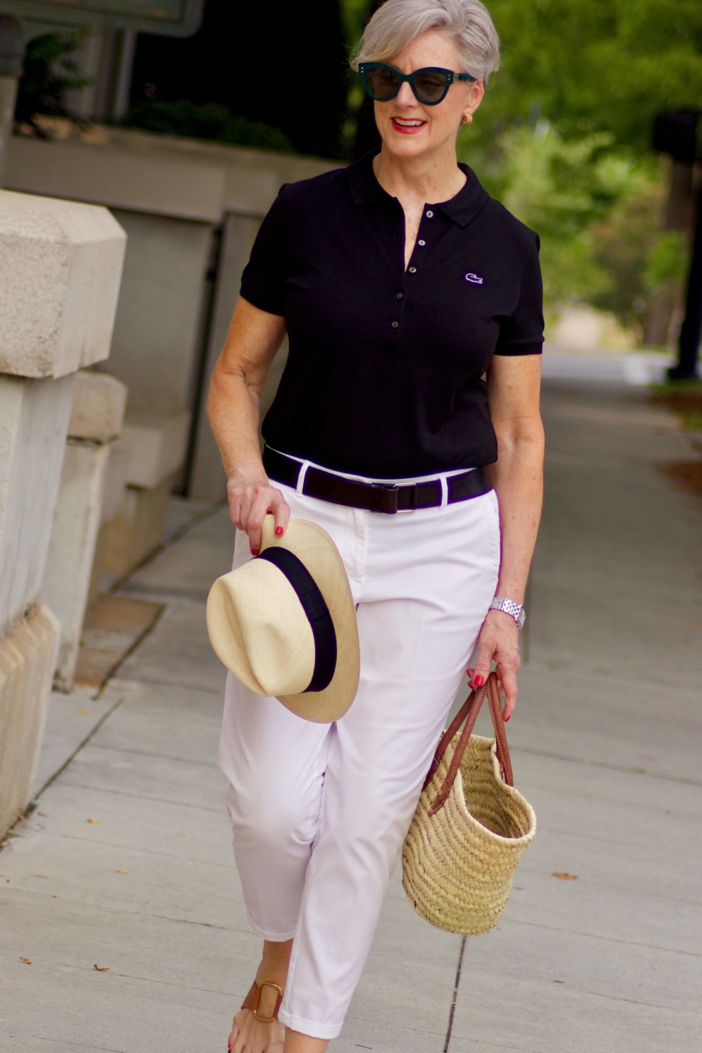 lacoste black polo, white chinos, brown sandals, straw tote