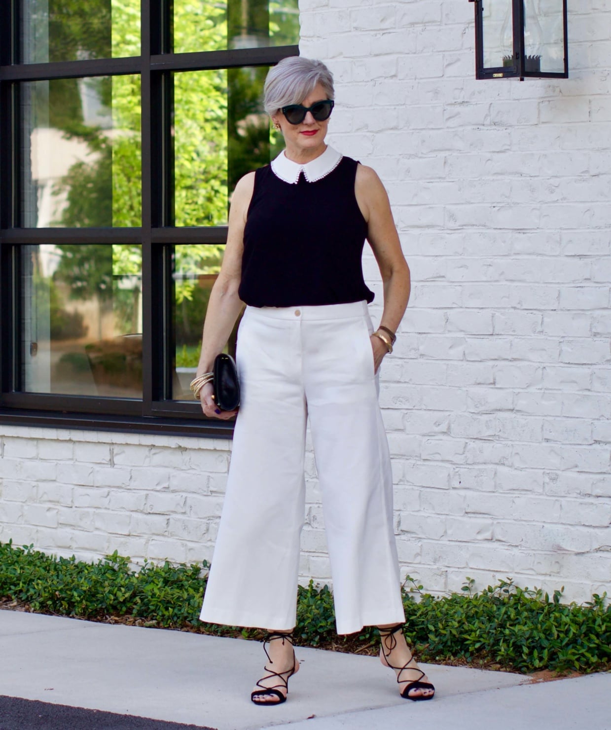 what to wear to work wide leg pants, black blouse, and suede sandals