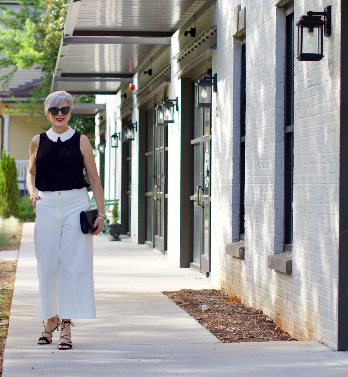 what to wear to work wide leg pants, black blouse, and suede sandals