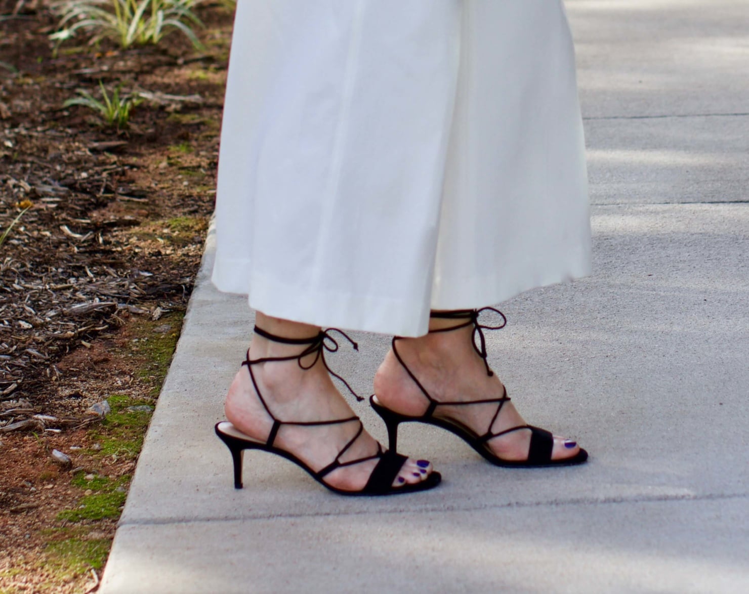 what to wear to work wide leg pants, black blouse, and suede sandals