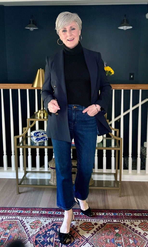 Woman over 60 wearing a black turtleneck and navy blazer