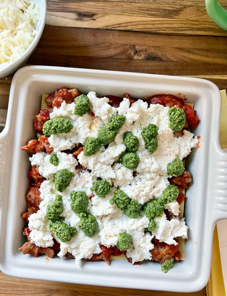 lasagna with ricotta and pesto dotting the top