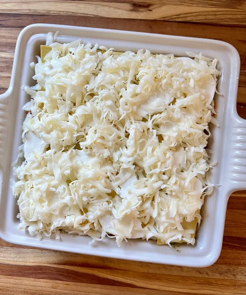 Lasagna ready to bak with cheese on top
