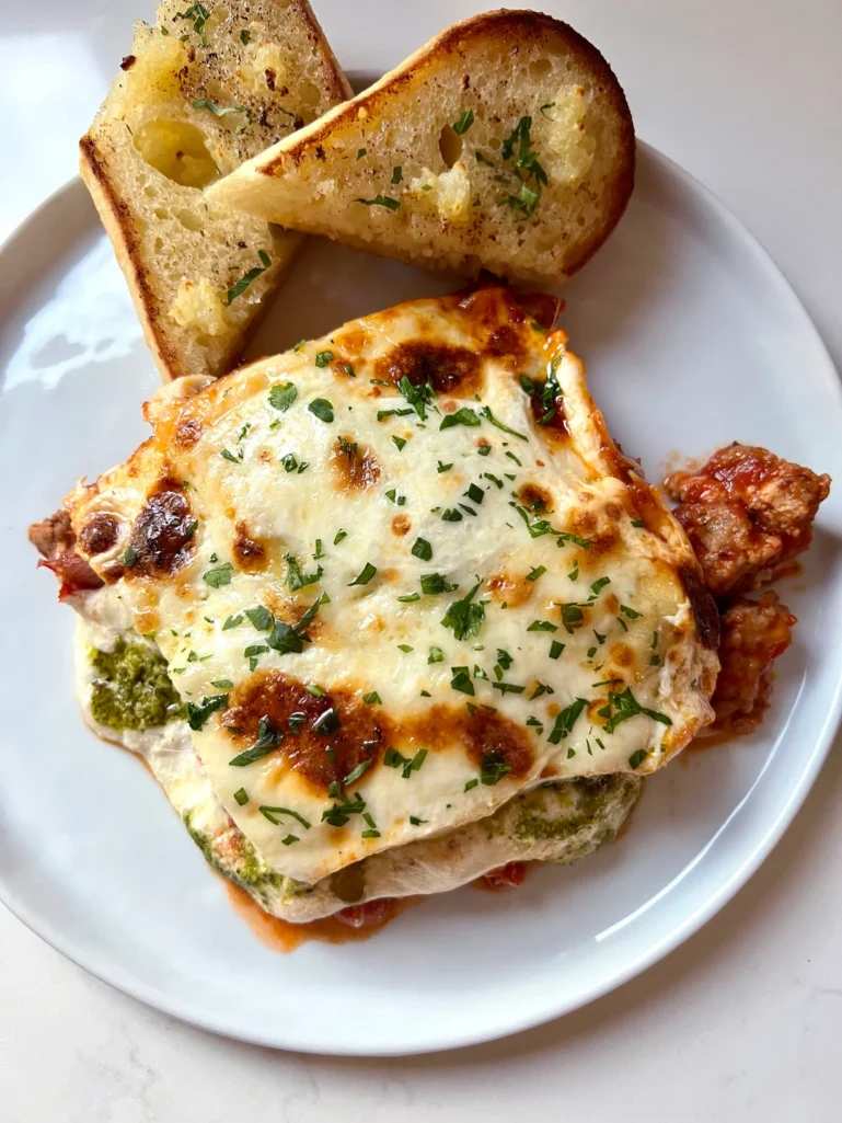 plated Christmas eve lasagna for two, with garlic bread