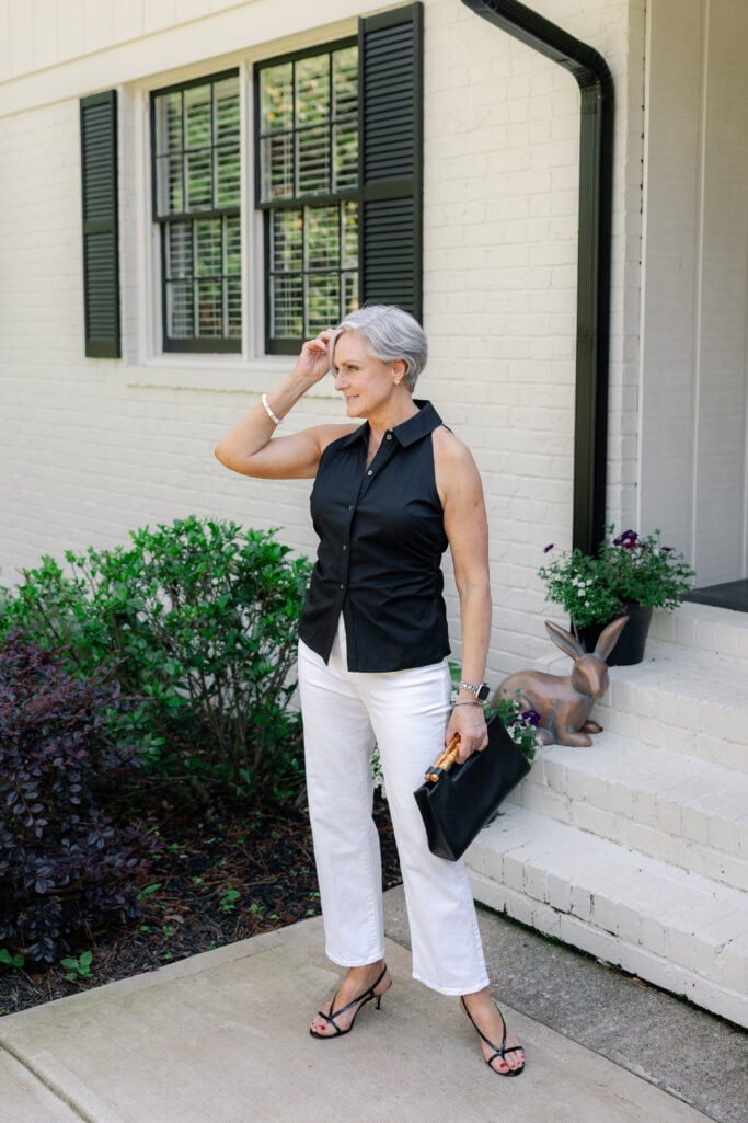 Look 2: Black sleeveless blouse with white jeans and strappy heels for an elevated, timeless summer look.