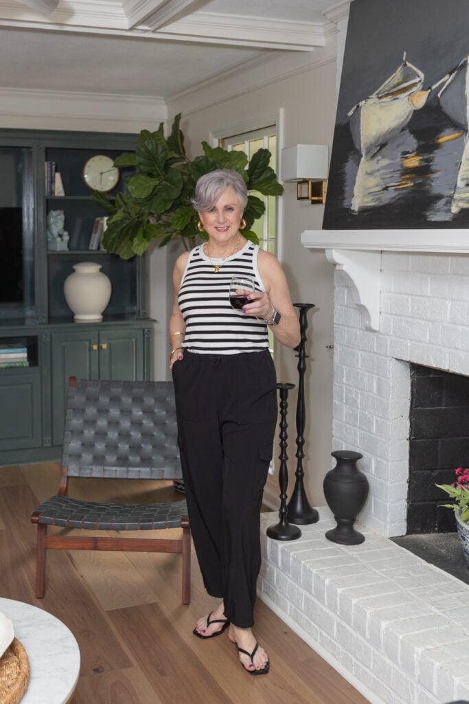 Neutral summer outfit styled with gold jewelry and contrast stripes