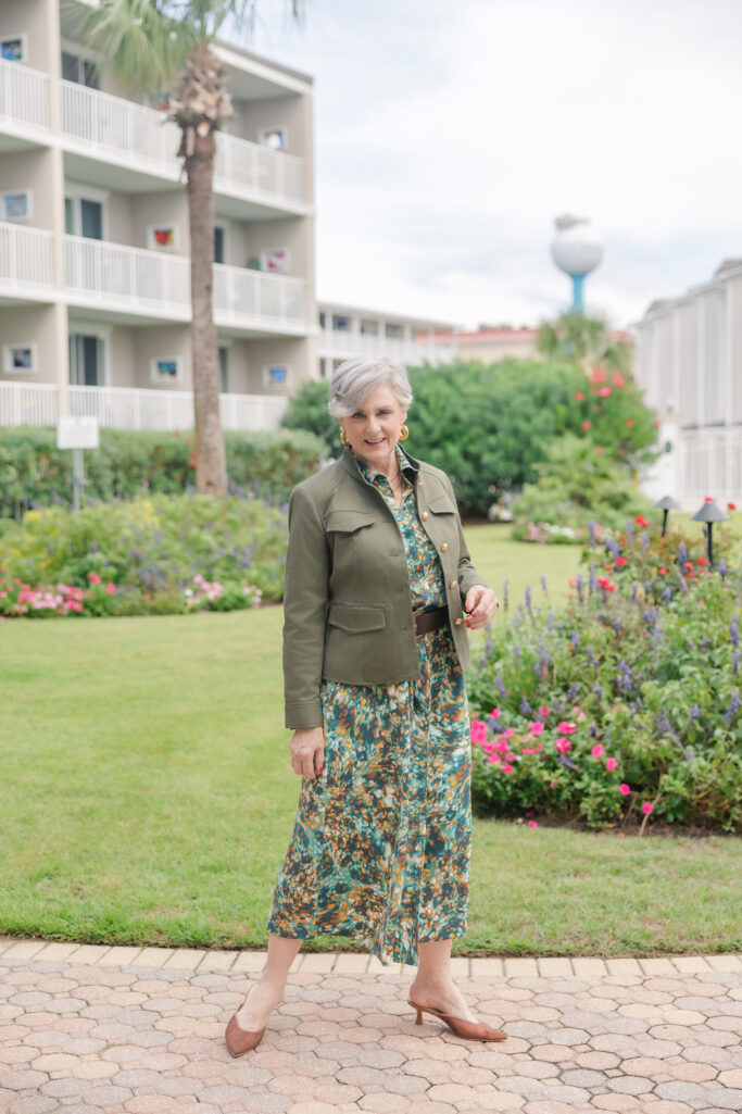 Beth Djalali styling a green utility jacket with printed dress for a modern fall look.