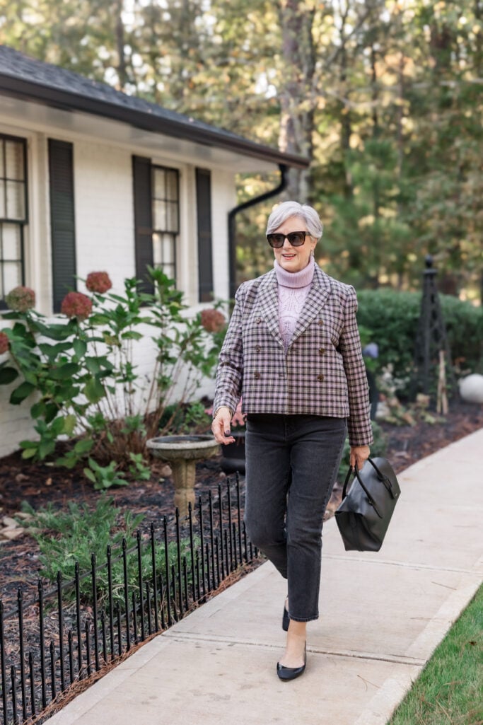 Beth Djalali wearing a plum plaid blazer and black denim.