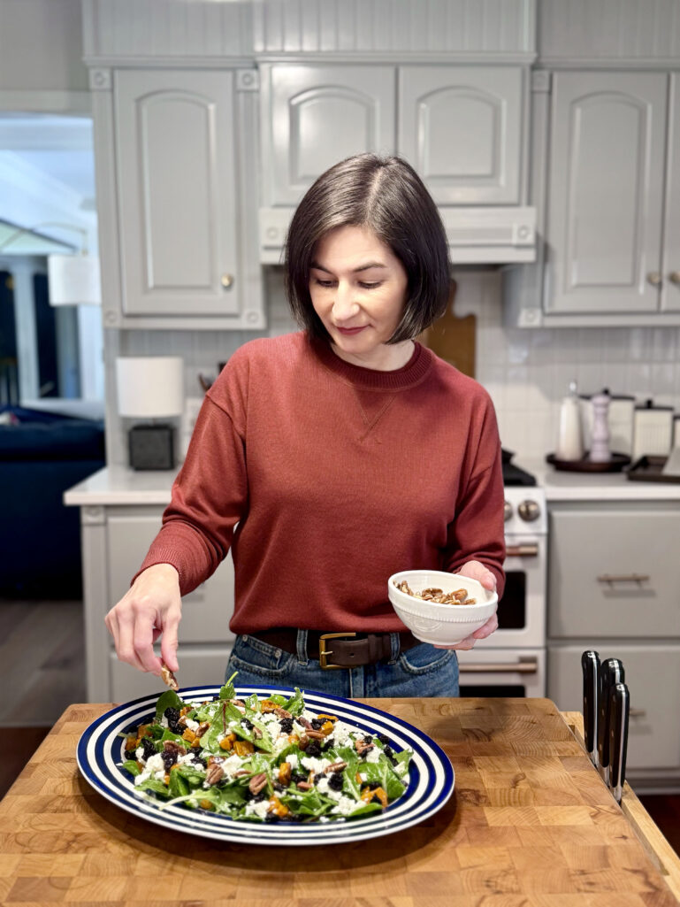Kelly preparing the roasted sweet potato and arugula salad