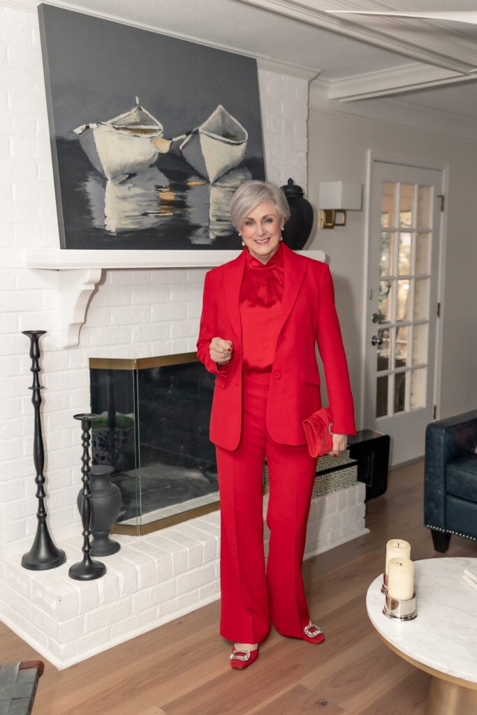 red holiday outfit for women over 50 — monochromatic suit