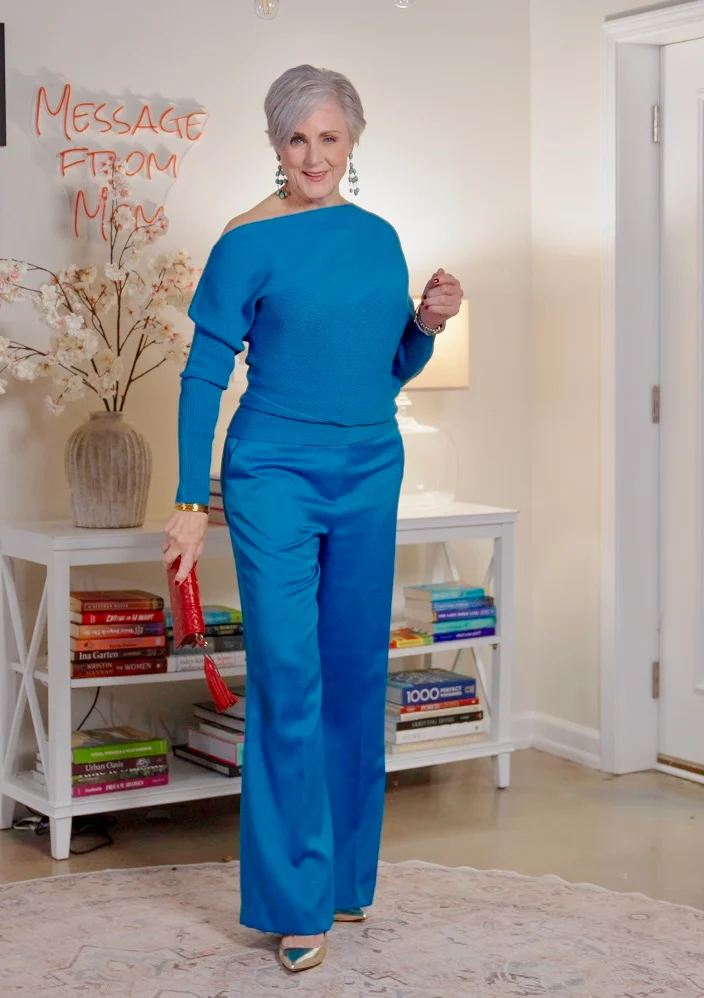 Beth wearing cobalt blue wide-leg pants with matching off-shoulder sweater and metallic pointed-toe pumps - dressy evening wide leg pants outfit for women over 50