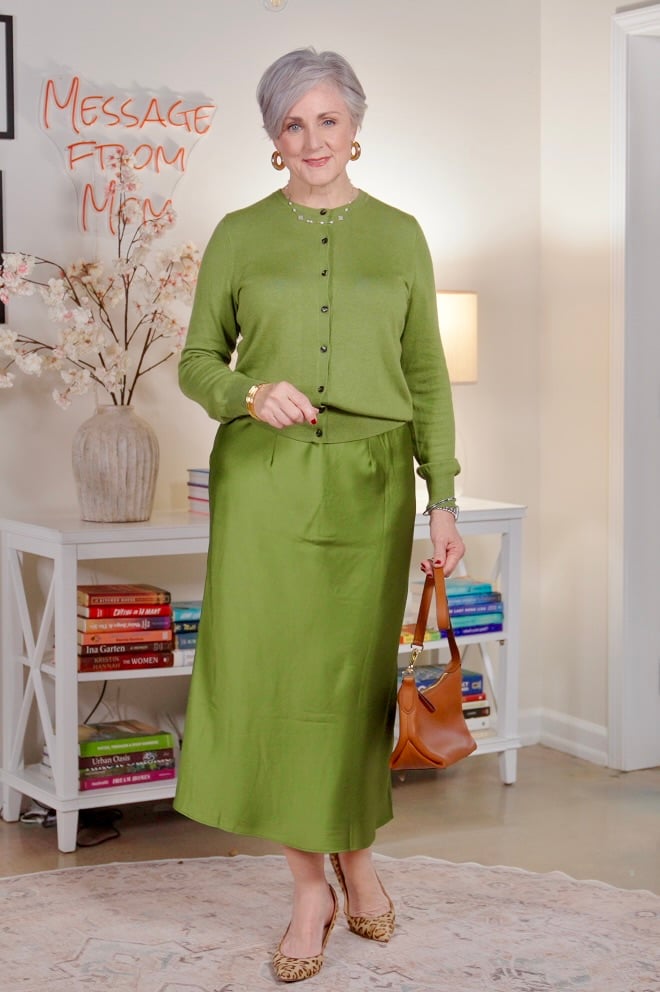 Beth Djalali wearing moss-green satin skirt and ivory top — modern green outfit inspiration for women over 50, fall 2025 color trends, earthy chic style