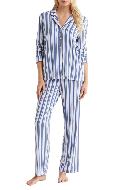 Nordstrom Moonlight Eco Knit Pajamas - Blue and White Stripe. Women’s blue-and-white striped pajama set featuring a long-sleeve button-front top with a relaxed fit and matching straight-leg pants, shown on a model standing barefoot.