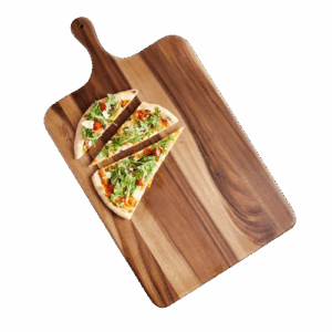 Acacia wood serving board with a paddle handle, shown with a sliced flatbread pizza topped with greens and vegetables arranged on the board.
