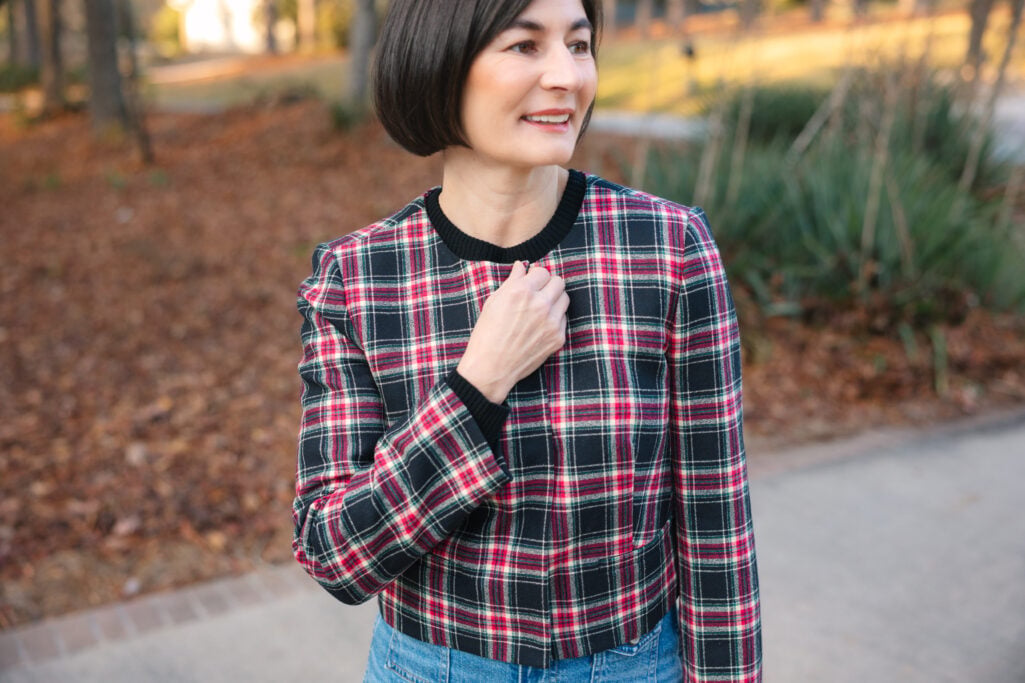 Close-up of Kelly in Stewart tartan plaid jacket showing festive holiday pattern and texture for petite casual styling