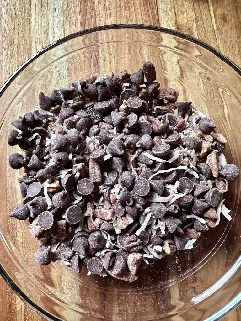 Completed streusel mixture with chocolate chips, coconut, and pecans coated in cinnamon sugar