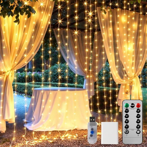 Brightown 300 LED warm white curtain string lights hanging behind sheer drapes outdoors, creating a sparkling backdrop with included USB plug and remote control shown in front.
