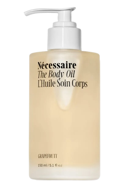 Bottle of Nécessaire The Body Oil in Grapefruit, a lightweight, fast-absorbing body oil infused with vitamins and plant oils to nourish and soften dry skin.
