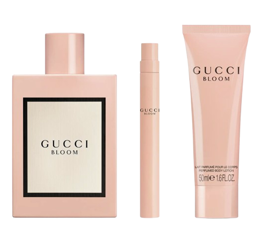 Gucci Bloom Eau de Parfum gift set featuring a blush-pink perfume bottle, a matching travel spray, and a scented body lotion, all in the signature Gucci Bloom floral fragrance.