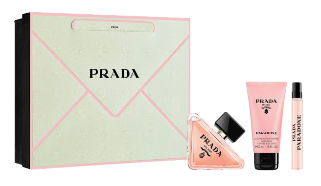 Prada Paradoxe Gift Set featuring a mint-green envelope-style box, a full-size triangular perfume bottle, a pink scented body lotion, and a matching travel spray in the signature Paradoxe fragrance.