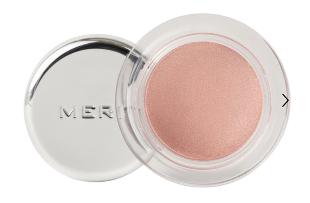 Merit Solo Shadow Cream Eyeshadow in an open silver compact, revealing the soft, shimmery blush-pink cream shadow inside.