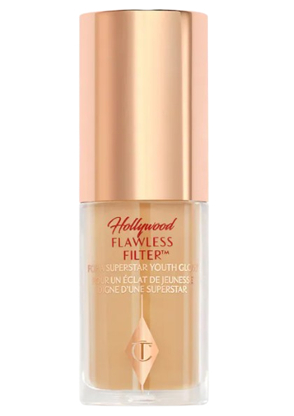 Charlotte Tilbury Mini Hollywood Flawless Filter in a clear glass tube with a rose-gold cap, filled with the signature glowing complexion booster.